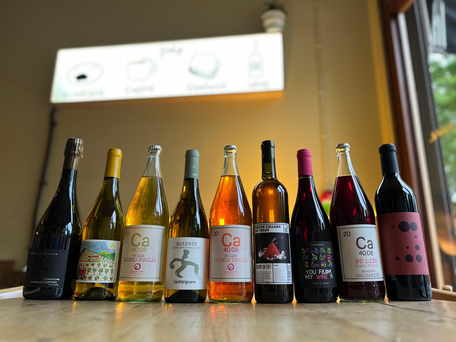 Row of wine bottles on a table with a blurred background