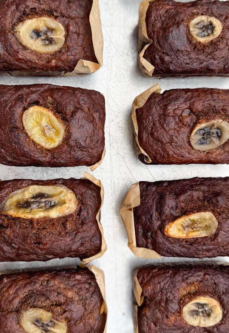 Delicious Vegan Mini Banana Bread Loaves by Pulp, showcasing a tray of moist and fluffy banana bread vegan loaves with caramelised banana slices on top, perfect for toasting and topping!